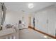Bright bedroom with a crib, large wardrobe, neutral walls and an open doorway to another room at 108 S Lincoln Ave, Tampa, FL 33609