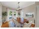 Dining room with a rustic wood table, seating for six, and sliding glass doors at 108 S Lincoln Ave, Tampa, FL 33609