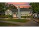 Charming home with fresh landscaping, beautiful light, and an American flag outside at 108 S Lincoln Ave, Tampa, FL 33609