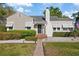 Charming single-Gathering home with a well-manicured lawn, brick walkway, and inviting entrance at 108 S Lincoln Ave, Tampa, FL 33609