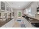 Bright kitchen with white cabinets, granite countertops, and stainless steel appliances at 108 S Lincoln Ave, Tampa, FL 33609