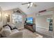 Cozy living room with vaulted ceilings, plank floors and an inviting sofa and television at 108 S Lincoln Ave, Tampa, FL 33609