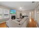 Inviting living room with fireplace, hardwood floors, and comfortable sectional sofa at 108 S Lincoln Ave, Tampa, FL 33609