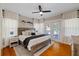 Comfortable main bedroom with a ceiling fan, wood floors, and doors leading to the outside at 108 S Lincoln Ave, Tampa, FL 33609