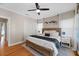 Comfortable main bedroom with ceiling fan, wood floors, and white closet doors at 108 S Lincoln Ave, Tampa, FL 33609