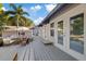 Wide outdoor patio with lounge chairs and outdoor dining set with palm trees in the background at 108 S Lincoln Ave, Tampa, FL 33609