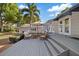 Outdoor patio with lounge furniture with the house in the background, and palm trees on a sunny day at 108 S Lincoln Ave, Tampa, FL 33609
