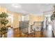 Upstairs hallway with hardwood floors, decorative railings, and access to multiple rooms at 10810 Lakeside Vista Dr, Riverview, FL 33569