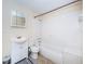 Cozy bathroom featuring a classic white tiled shower and vanity with ample storage space at 1104 E Genesee St, Tampa, FL 33603