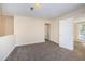 Neutral bedroom featuring carpet, cream walls, and white trim with passage to next room at 1104 E Genesee St, Tampa, FL 33603