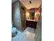 Bathroom featuring a vanity with dark wood cabinets, decorative fixtures, and a walk-in shower at 1200 N Shore Ne Dr # 212, St Petersburg, FL 33701