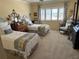 Bright bedroom featuring twin beds with blue and yellow accents, white shutters, and comfortable seating at 1200 N Shore Ne Dr # 212, St Petersburg, FL 33701