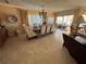 Open-concept dining area with a large table, chandelier, and access to the outdoor patio at 1200 N Shore Ne Dr # 212, St Petersburg, FL 33701