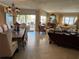 Dining area adjacent to the living room with balcony access and chandelier lighting at 1200 N Shore Ne Dr # 212, St Petersburg, FL 33701