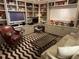 Cozy living room features custom built-ins, a comfortable chair, and a decorative rug at 1200 N Shore Ne Dr # 212, St Petersburg, FL 33701