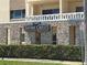 Close-up view of Shore Crest signage on stone wall, with a hedge, and a street sign at 1200 N Shore Ne Dr # 212, St Petersburg, FL 33701