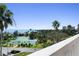 Scenic view of the tennis courts, ocean, and lush foliage from the condo balcony at 1200 N Shore Ne Dr # 212, St Petersburg, FL 33701