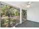 View of the screened-in patio featuring a ceiling fan and a view of the home's landscaped backyard at 12004 N 53Rd St, Temple Terrace, FL 33617