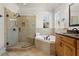 Elegant bathroom featuring walk-in shower with bench, soaking tub, and vanity at 123 14Th Ne Ave, St Petersburg, FL 33701