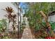 Beautiful brick path leading through a landscaped garden with an archway, plants, and foliage enhancing outdoor appeal at 123 14Th Ne Ave, St Petersburg, FL 33701