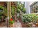 Covered brick patio with hanging plants, ceiling fan, lush landscaping, and an inviting outdoor area for relaxation at 123 14Th Ne Ave, St Petersburg, FL 33701