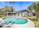 Backyard pool and patio area with well-maintained single-Gathering home at 1366 Wexford N Dr, Palm Harbor, FL 34683