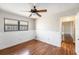 Well-lit bedroom featuring wood-look floors and bright wainscoting, creating a cozy feel at 1366 Wexford N Dr, Palm Harbor, FL 34683