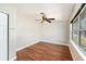 Bright bedroom with wood floors, ceiling fan, and natural light from the window at 1366 Wexford N Dr, Palm Harbor, FL 34683