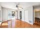 Bedroom featuring wood floors, a ceiling fan, ensuite bathroom, and doors leading to the pool at 1366 Wexford N Dr, Palm Harbor, FL 34683