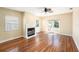 Light-filled living room boasts hardwood floors, a fireplace, and glass patio doors at 1366 Wexford N Dr, Palm Harbor, FL 34683