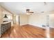 Spacious living area with wood floors, breakfast bar, and a view into the updated kitchen at 1366 Wexford N Dr, Palm Harbor, FL 34683