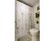 Bathroom featuring a flower-patterned shower curtain and coordinated accessories at 14130 Rosemary Ln # 1201, Largo, FL 33774