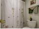 Bathroom featuring a flower-patterned shower curtain and coordinated accessories at 14130 Rosemary Ln # 1201, Largo, FL 33774