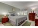 Comfortable bedroom featuring a queen-size bed, stylish decor, and natural light at 14130 Rosemary Ln # 1201, Largo, FL 33774