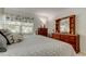 Comfortable bedroom with a soft color palette, wood furnishings, and a bright window view at 14130 Rosemary Ln # 1201, Largo, FL 33774