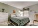 Bedroom featuring a bed, dresser, window, and coordinated decor at 14130 Rosemary Ln # 1201, Largo, FL 33774