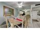 Dining area open to the kitchen features a charming light fixture and tile flooring at 14130 Rosemary Ln # 1201, Largo, FL 33774