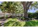 Picture-perfect front yard with lush green grass and mature landscaping at 14130 Rosemary Ln # 1201, Largo, FL 33774