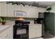 A charming kitchen, featuring white cabinetry and modern appliances in a well-lit space at 14130 Rosemary Ln # 1201, Largo, FL 33774