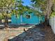 Backyard view of a turquoise house with access to the rear entrance at 1504 E 33Rd Ave, Tampa, FL 33610