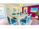 Bright dining room with a marble-top table, colorful accents, and access to an outdoor patio at 1515 Arrowhead Dr, Sun City Center, FL 33573