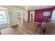 Dining area featuring wood floors, a view into other rooms, and a vintage piano at 1515 Arrowhead Dr, Sun City Center, FL 33573
