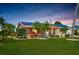 Charming single-story home with solar panels, well-maintained landscaping, and a lush green lawn at 1515 Arrowhead Dr, Sun City Center, FL 33573