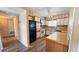 Functional kitchen with white cabinets, classic appliances, and wood-look flooring at 1515 Arrowhead Dr, Sun City Center, FL 33573