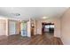 Spacious living area featuring wood floors, ample natural light, and a view into the dining area at 1515 Arrowhead Dr, Sun City Center, FL 33573