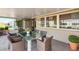 Covered patio with a glass table, seating, and view of the yard at 1515 Arrowhead Dr, Sun City Center, FL 33573