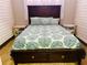 Bedroom featuring a dark wood bed and drawers, plus neutral decor at 1516 Arrowhead Dr, Sun City Center, FL 33573