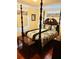 Bedroom featuring a decorative dark wood four poster bed and bedside tables at 1516 Arrowhead Dr, Sun City Center, FL 33573