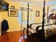 Bedroom featuring a decorative dark wood four poster bed and decor at 1516 Arrowhead Dr, Sun City Center, FL 33573