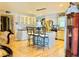 Bright kitchen featuring a central island with bar seating, updated appliances, and ample cabinet space at 1516 Arrowhead Dr, Sun City Center, FL 33573